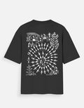 Back_Tribal Spiral Warli Art oversized graphic T-shirt by SWARNAMANTRA inspired by Indian tribal artwork and modern streetwear fashion.